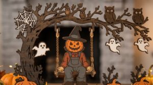 Close-up of a pumpkin-head scarecrow on a swing surrounded by owls, ghosts and a spider web