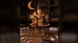 Layered laser cut flying castle with bats and a crescent moon on a dark shelf