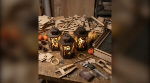 Laser cut Halloween lanterns on a workbench surrounded by plywood parts and measuring tools